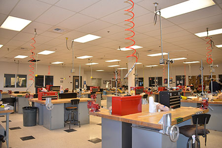 O&P lab full of individual workstations with tool sets and equipment